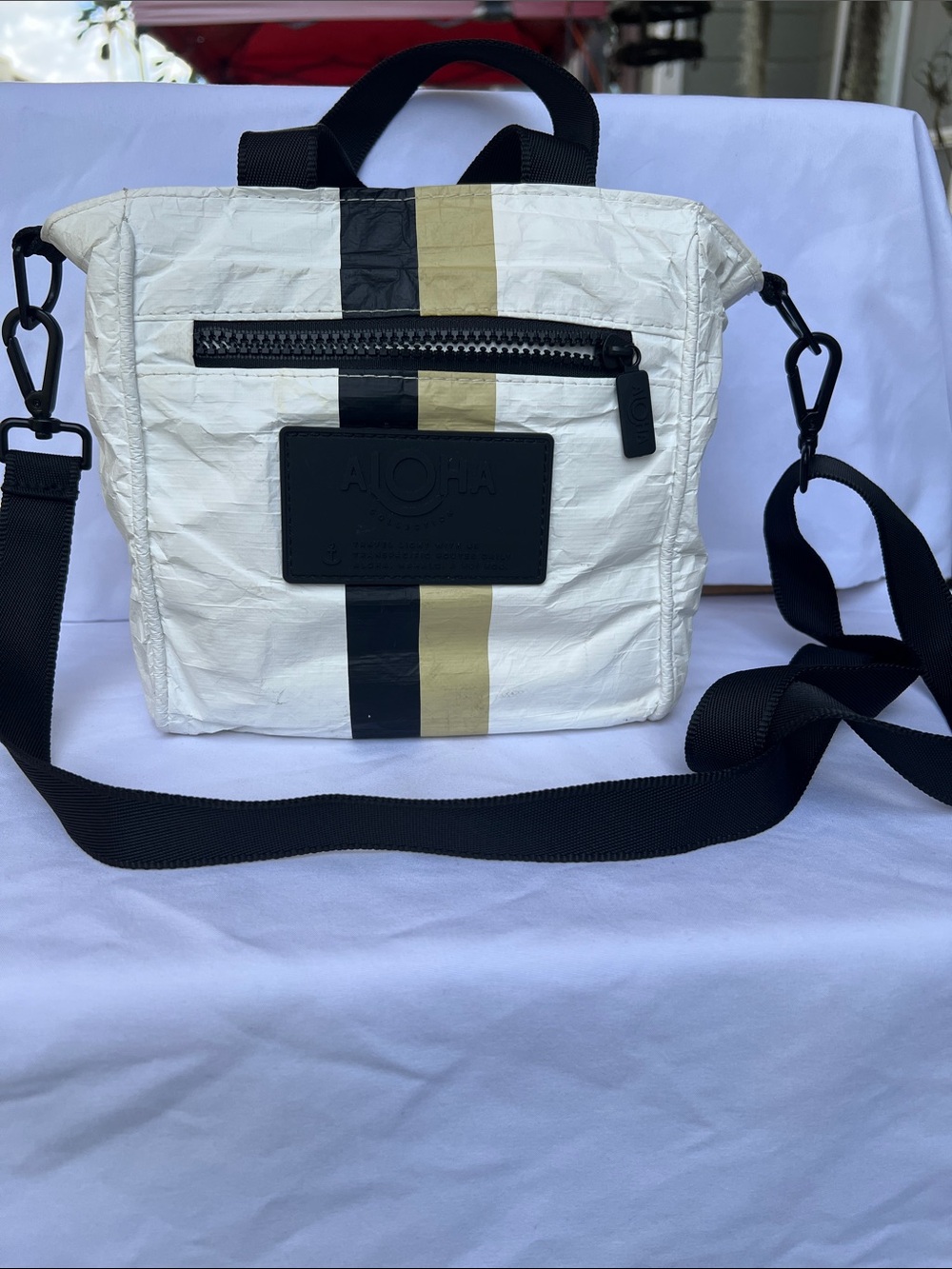 ALOHA Collection White Crossbody Bag with Black and Gold Stripes